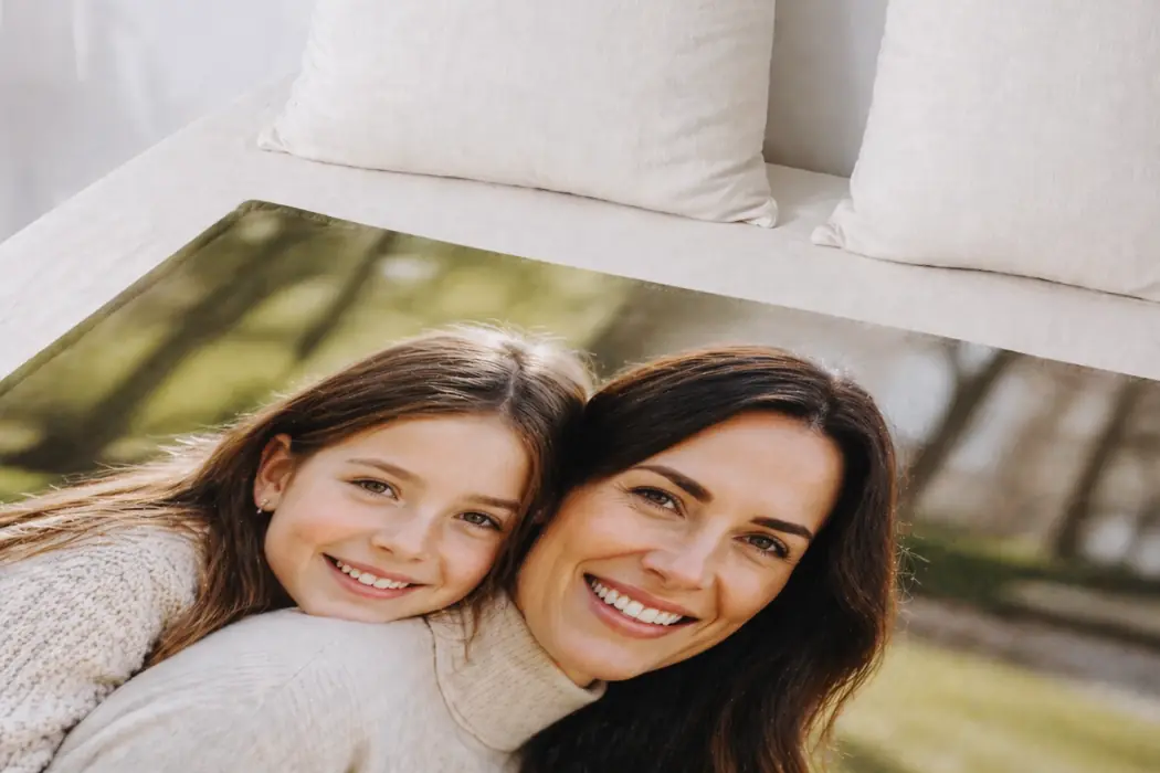 A photo blanket printed with a mother and her daughter, on a sofa