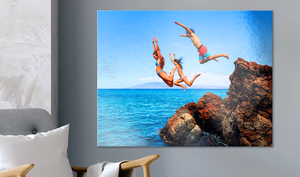 Personalised metal photo print: Three friends leap from rocks into a vibrant turquoise ocean. A stunning, bespoke piece for your home.