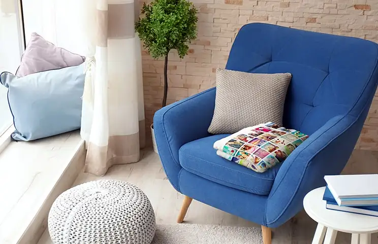 Collage blanket on blue chair