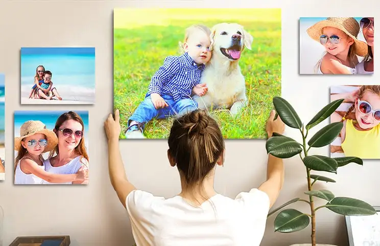 Woman placing canvas print on wall