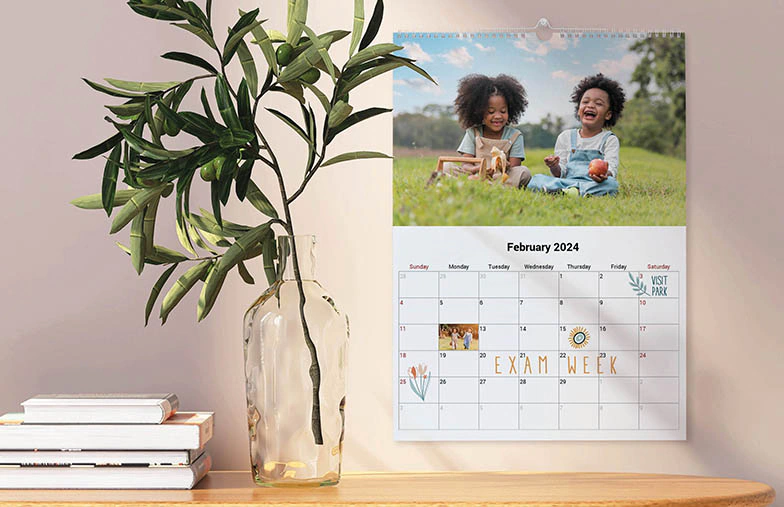 Dog photos on custom design photo calendar hung up on wall